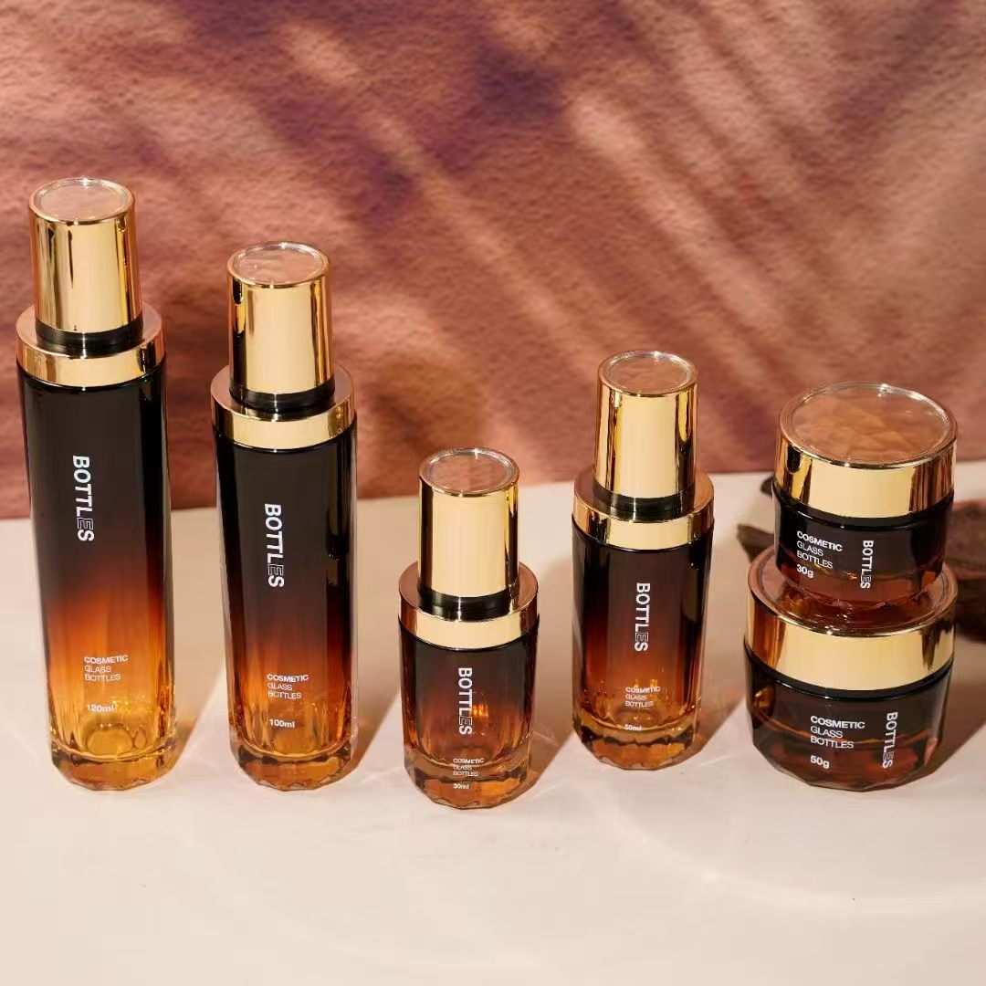 Custom luxury cosmetic glass bottle set in black and gold gradient
